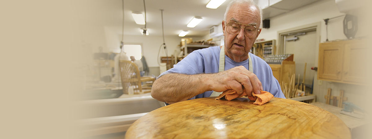 Residents caning chairs in the Brethren Village woodshop