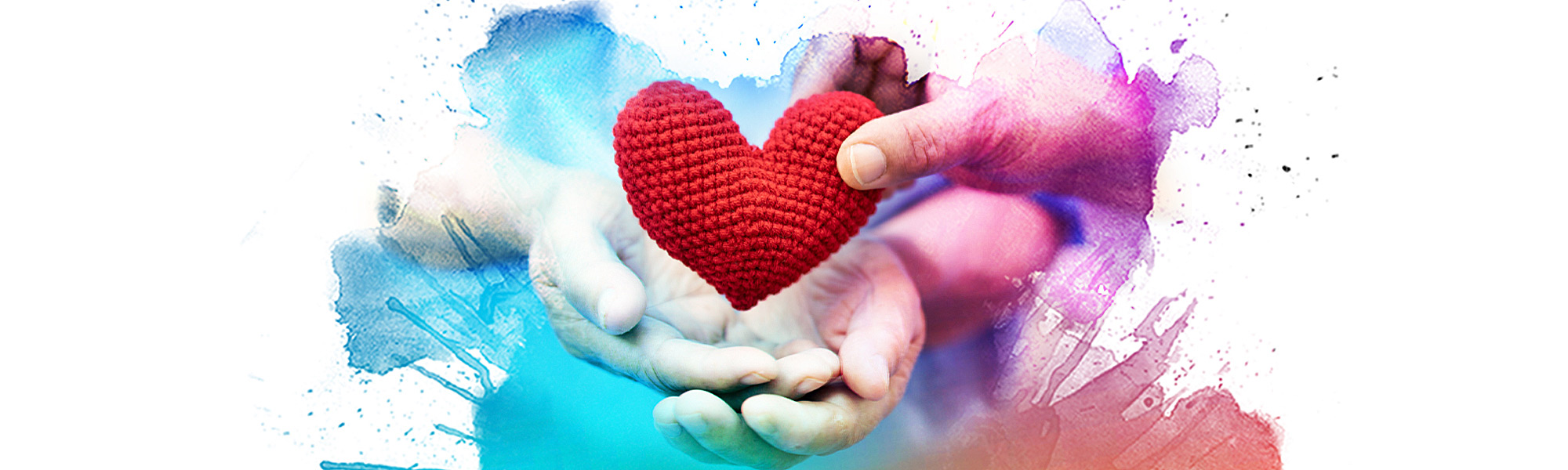 Cupped hands receiving a crocheted heart