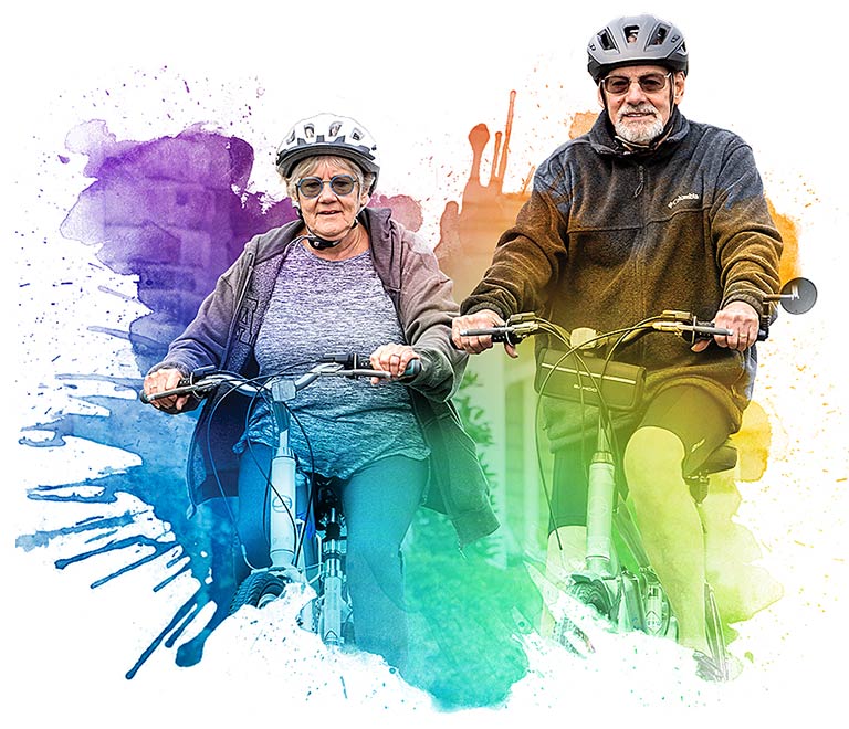Resident couple enjoying a bicycle ride on campus