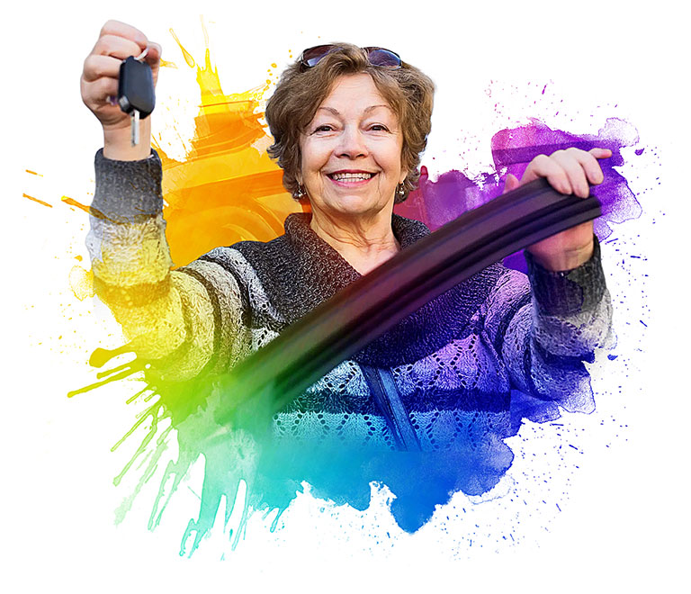 Woman standing behind door of a car she's about to donate and holding up key