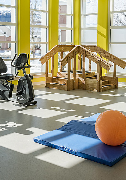 physical therapy room with stairs, exercise bikes, ball and mat